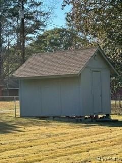 view of outbuilding with a yard