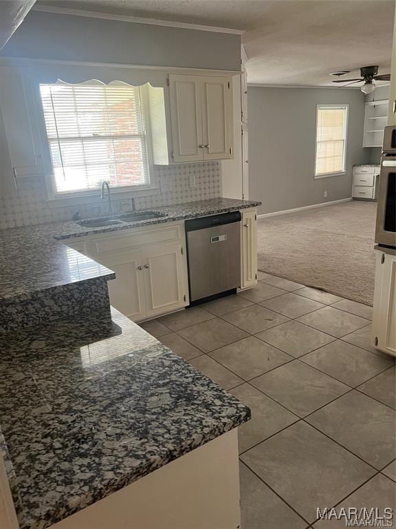 kitchen featuring white cabinets, a healthy amount of sunlight, sink, and appliances with stainless steel finishes