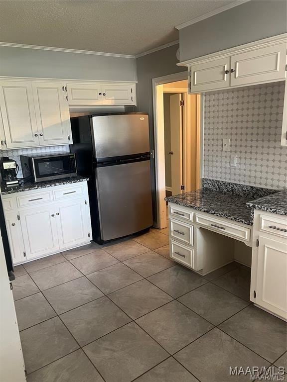 kitchen featuring white cabinetry, backsplash, and appliances with stainless steel finishes