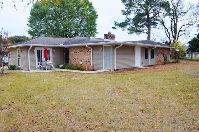 back of house featuring a patio and a lawn