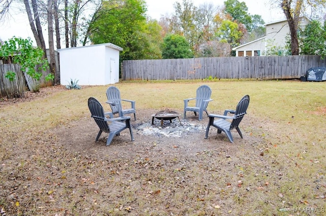 view of yard with a fire pit and a storage shed