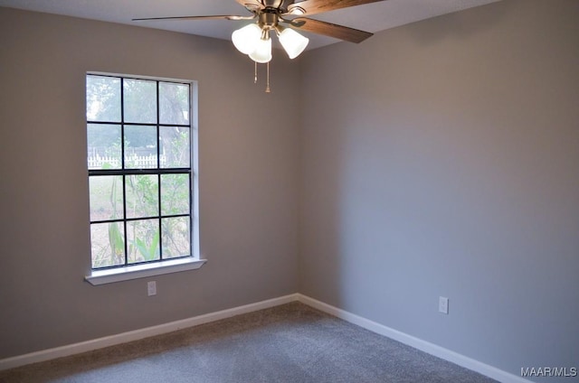 carpeted empty room with a wealth of natural light and ceiling fan