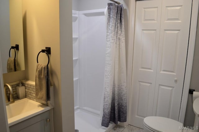 bathroom featuring vanity, toilet, and curtained shower