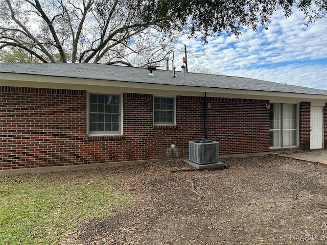 view of side of home featuring central AC unit