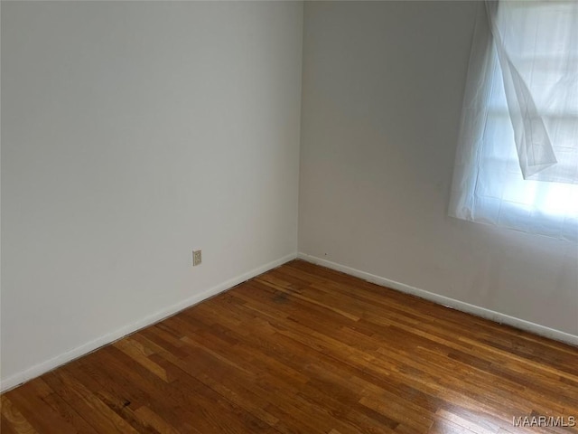 unfurnished room with hardwood / wood-style flooring