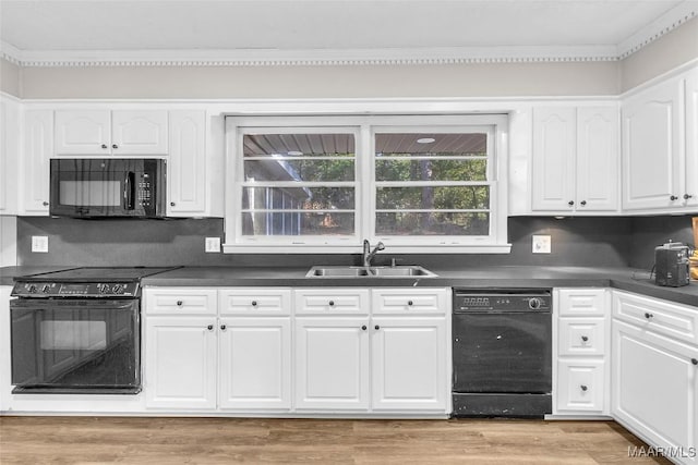 kitchen with decorative backsplash, sink, black appliances, light hardwood / wood-style flooring, and white cabinets