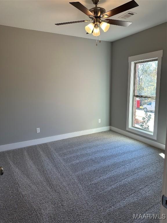 carpeted empty room featuring ceiling fan