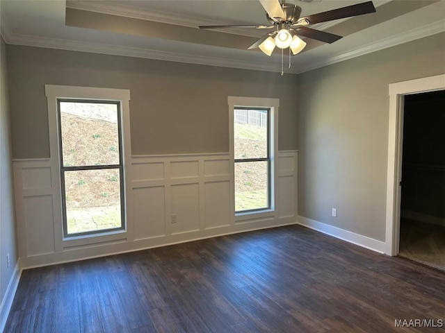 spare room with ceiling fan, dark hardwood / wood-style flooring, and ornamental molding