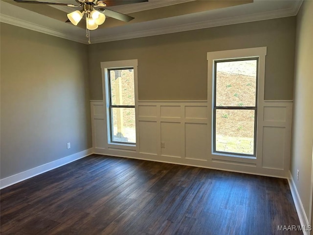 spare room with dark wood-type flooring, ceiling fan, and crown molding