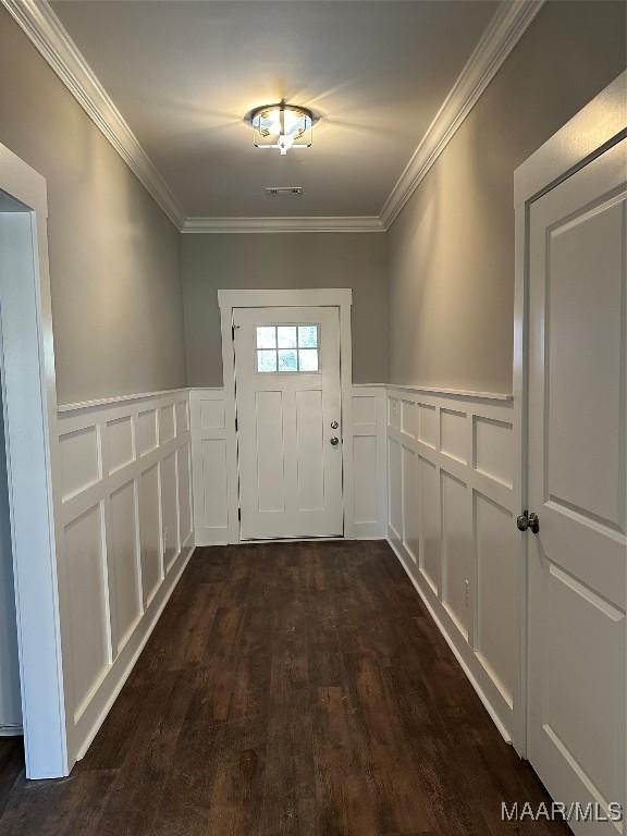 entryway featuring ornamental molding and dark wood-type flooring