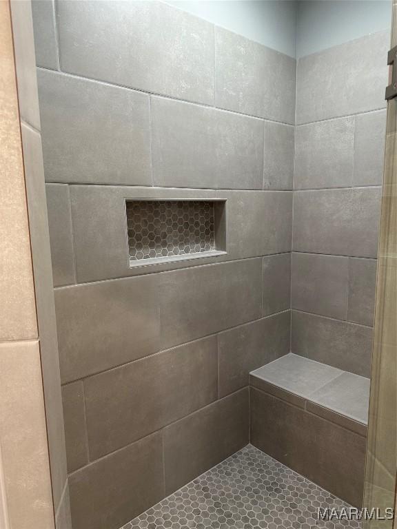 bathroom with tiled shower