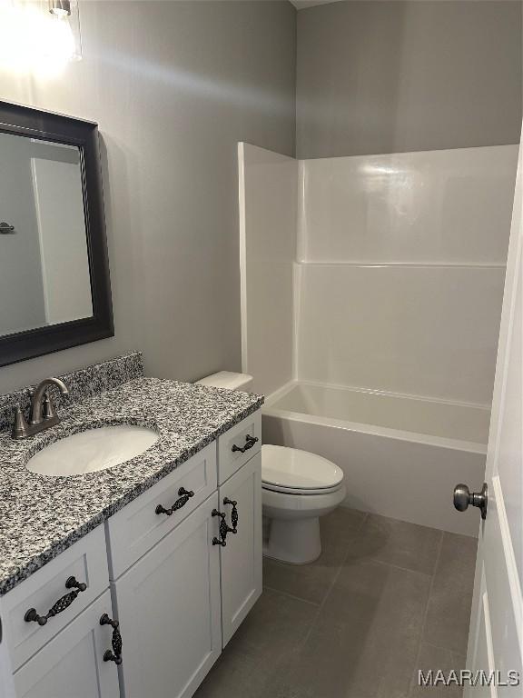 full bathroom with tile patterned flooring, shower / tub combination, vanity, and toilet