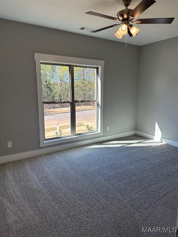 carpeted empty room featuring ceiling fan