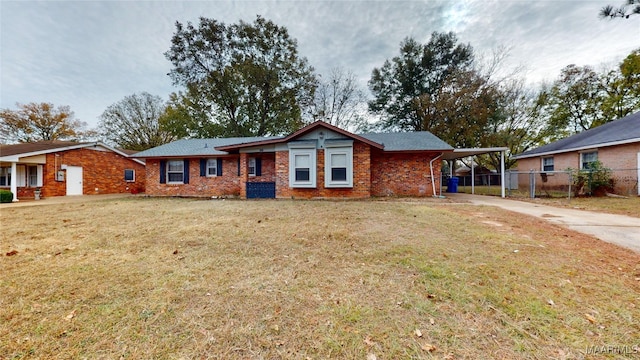 ranch-style house featuring a front yard and a carport