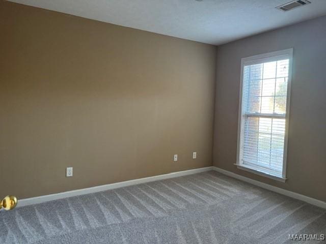 unfurnished room featuring carpet flooring