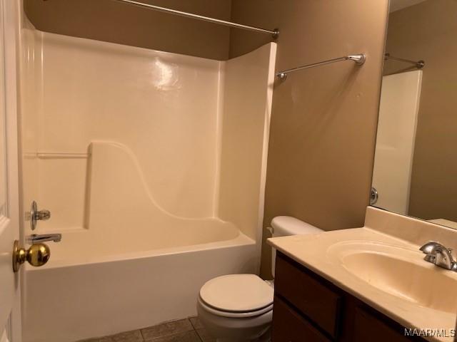 full bathroom with shower / tub combination, tile patterned flooring, vanity, and toilet