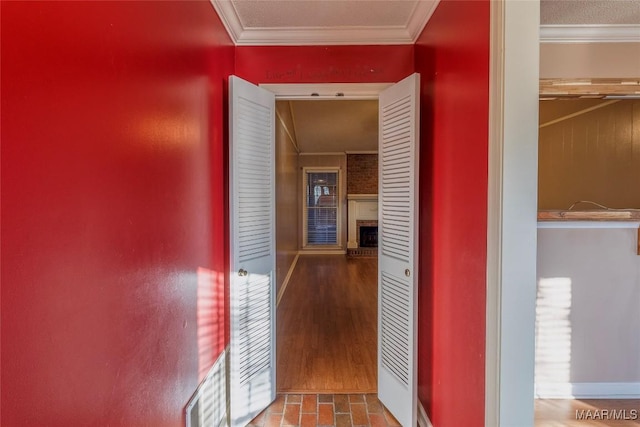 corridor with hardwood / wood-style flooring and ornamental molding