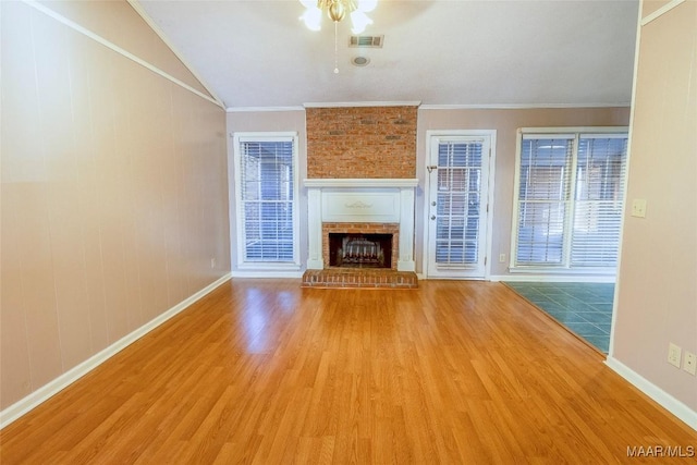 unfurnished living room with ceiling fan, a fireplace, light hardwood / wood-style floors, and ornamental molding