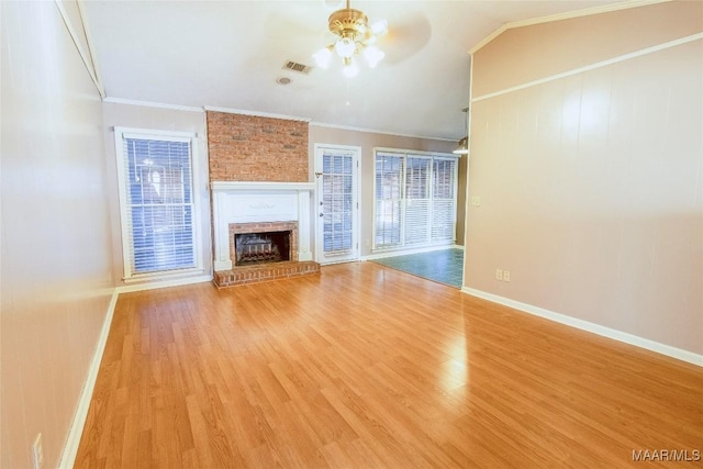 unfurnished living room with light hardwood / wood-style floors, a brick fireplace, ceiling fan, and ornamental molding