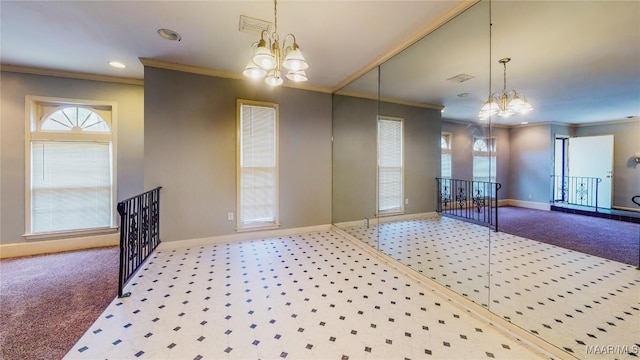 interior space with carpet floors, ornamental molding, and an inviting chandelier