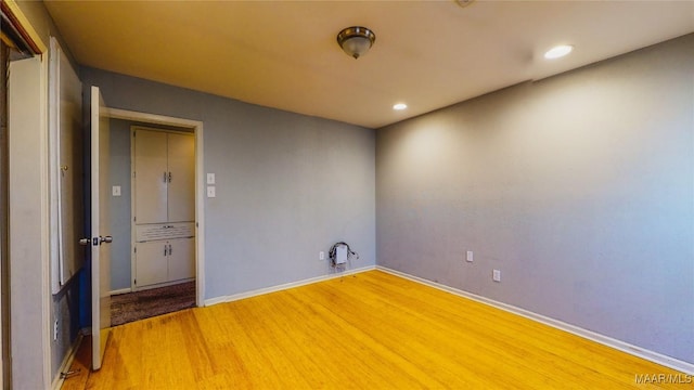 unfurnished room with wood-type flooring