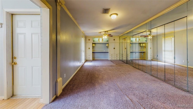 hallway with carpet flooring and ornamental molding