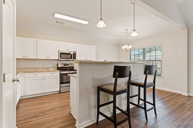 kitchen featuring white cabinets, dark hardwood / wood-style flooring, and stainless steel appliances