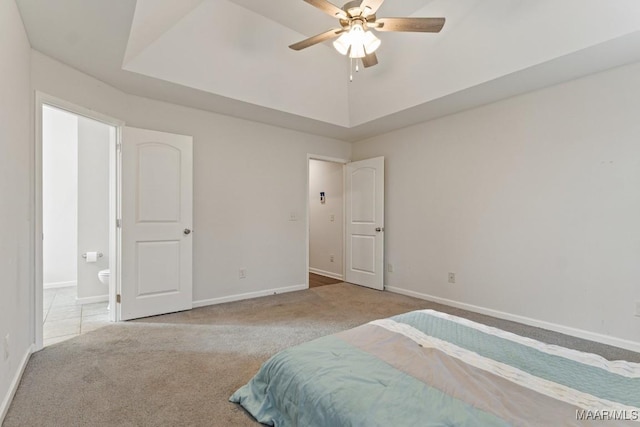 bedroom with connected bathroom, ceiling fan, and light colored carpet