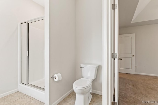 bathroom with tile patterned floors, toilet, and walk in shower