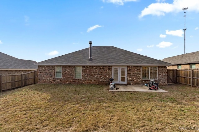 rear view of house featuring a patio area and a lawn