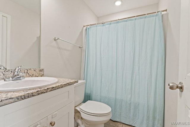 bathroom with tile patterned floors, vanity, and toilet