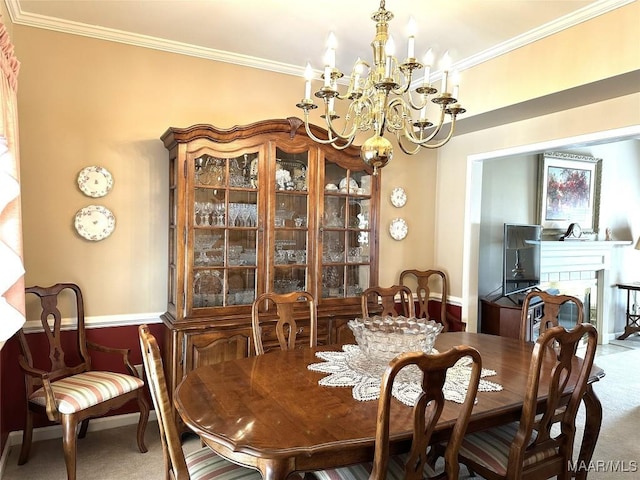 dining room featuring carpet flooring, a notable chandelier, and crown molding