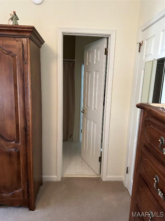 hallway with light colored carpet