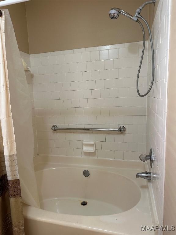 bathroom with shower / bath combination with curtain