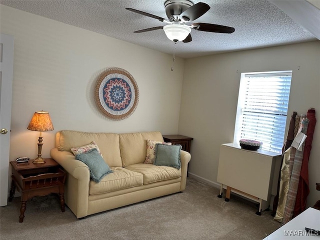 living room with carpet flooring, ceiling fan, and a textured ceiling