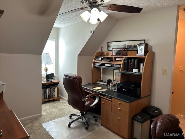 office area featuring a textured ceiling, light colored carpet, ceiling fan, and lofted ceiling