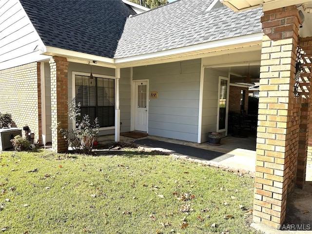 view of exterior entry with a lawn