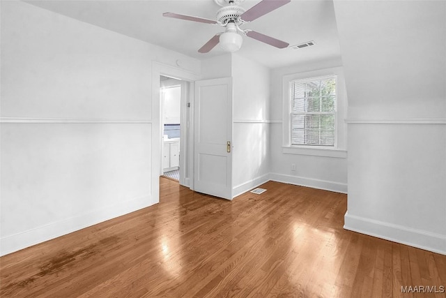 empty room with ceiling fan and wood-type flooring