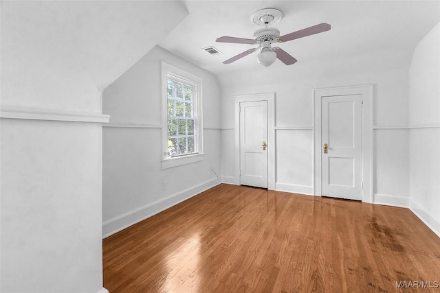 additional living space featuring ceiling fan, vaulted ceiling, and light wood-type flooring