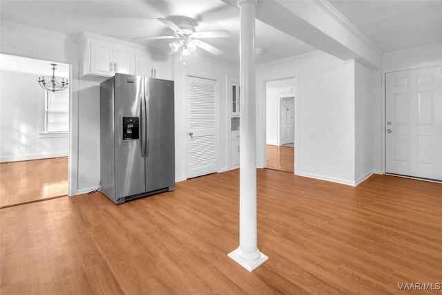 kitchen featuring light wood-type flooring, ceiling fan with notable chandelier, crown molding, stainless steel fridge with ice dispenser, and white cabinetry