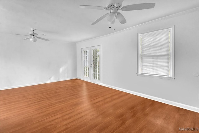 unfurnished room featuring ceiling fan, wood-type flooring, crown molding, and french doors