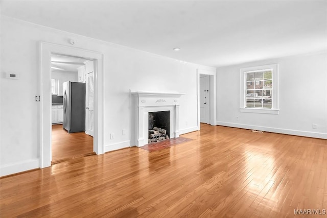 unfurnished living room with hardwood / wood-style floors