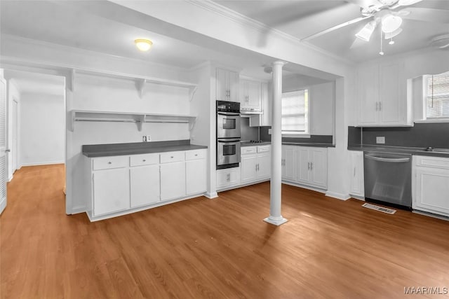 kitchen featuring ceiling fan, ornamental molding, appliances with stainless steel finishes, light hardwood / wood-style floors, and white cabinetry