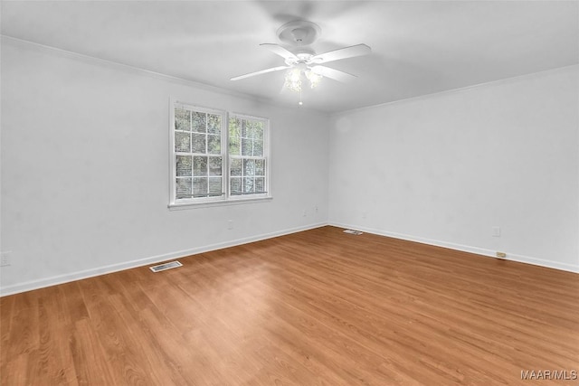 spare room with ceiling fan, light hardwood / wood-style flooring, and ornamental molding