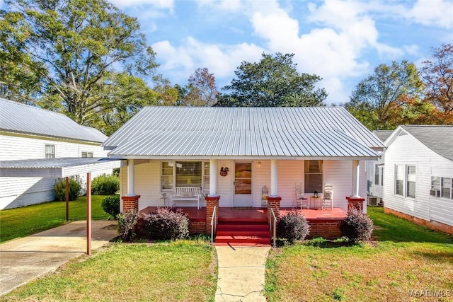 bungalow-style house featuring covered porch, central AC, and a front yard