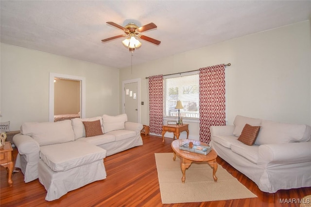 living room featuring hardwood / wood-style flooring and ceiling fan