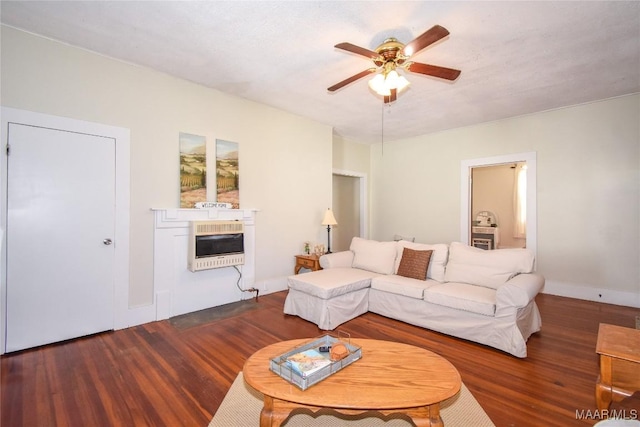 living room with dark hardwood / wood-style floors, ceiling fan, and heating unit