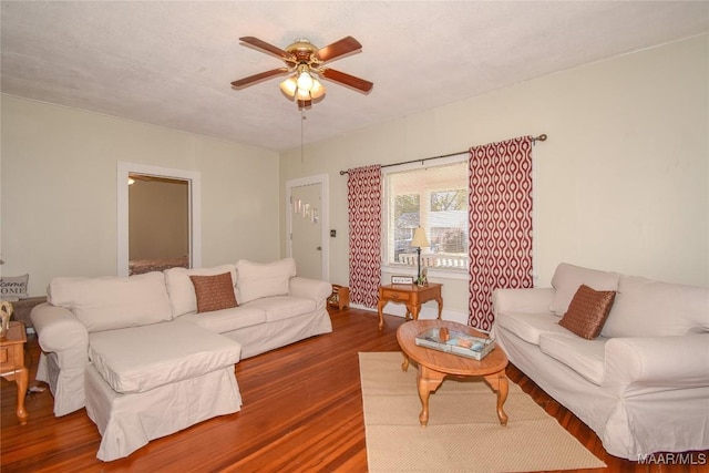 living room with dark hardwood / wood-style floors and ceiling fan