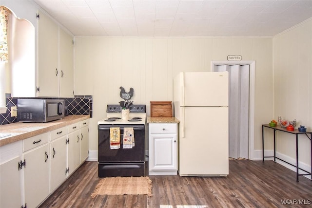 kitchen featuring white cabinets, ornamental molding, black electric range, white fridge, and dark hardwood / wood-style floors