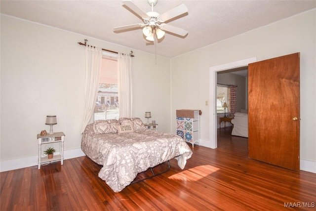 bedroom featuring dark hardwood / wood-style flooring and ceiling fan